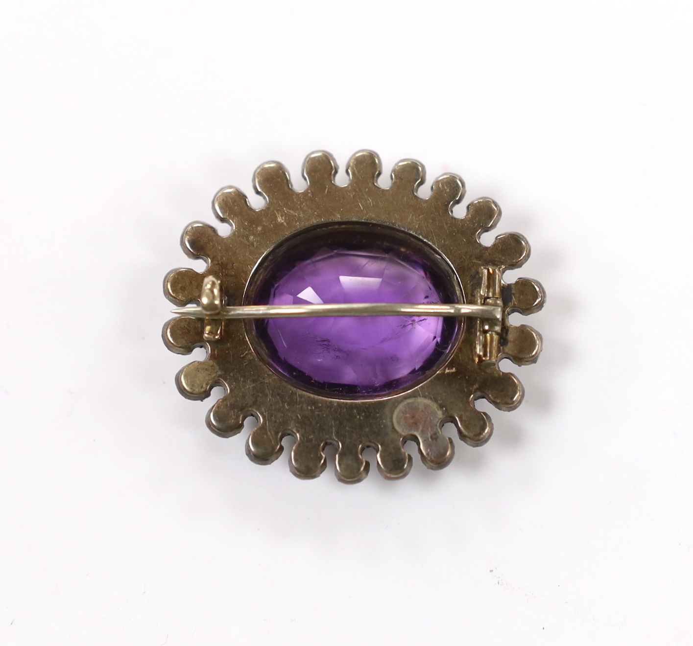 An early 20th century yellow and white metal, amethyst and paste set oval cluster brooch, 33mm.